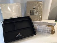 Overall lot showing black drawer tray, white dividers, clear containers, packaged fabric cubes and SmÅRASSEL boxes