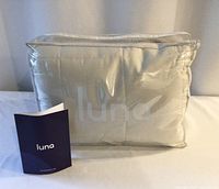 Blanket in clear plastic bag with booklet