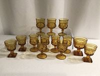 Full set of 12 amber footed glasses, two styles visible