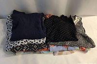 Stack of folded tops showing colours and patterns