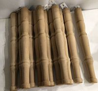 Twelve turned hemlock legs laid out side by side