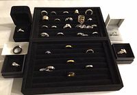 Overview of two ring trays and boxed rings showing variety of designs and finishes