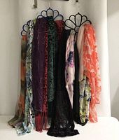 Scarves hanging on three scarf hangers