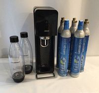 Machine, two bottles, six CO₂ cylinders group view