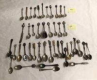 All souvenir spoons laid out in four rows