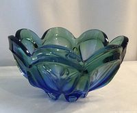 Oblique view showing green to blue gradient, footed base, scalloped rim