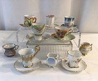 Group shot showing all demitasse cup sets, creamer, and bud vase
