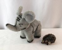 Full view of both plush toys, hedgehog and elephant
