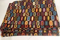 Stack of nine multicolour geometric placemats