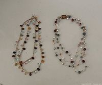 Both necklaces laid flat showing overall designs and colours