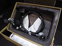 Regulator and hose inside fitted foam packaging