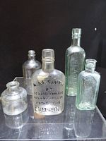 Group shot of all five antique glass bottles