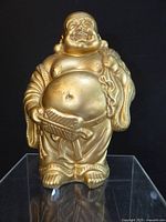 Front view of gold Laughing Buddha figurine