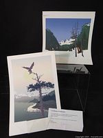 Two prints displayed with certificate overview