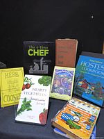 Group shot showing all seven cookbooks standing and lying flat