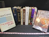 Front view of all ten hardcover books standing upright