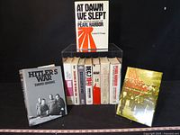 Group shot of all books standing and lying, shows quantity and main titles