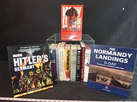 Group view of all books in lot, three featured titles outside bin, others in clear bin