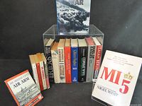 Group shot of all books arranged with one book displayed on acrylic stand