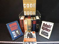 Group shot of all books displayed around acrylic box