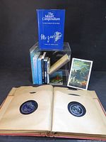 Group shot showing The Mozart Compendium, assorted books and open 78 rpm record album