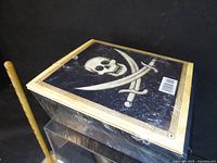Sealed pirate skull box on acrylic stand
