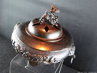 Top angled view showing lid, finial, patina