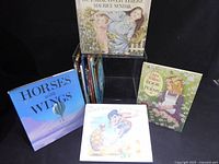 Group shot of entire lot showing stack of books and four highlighted titles