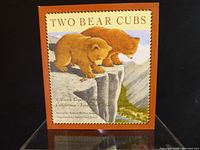 Cover of “Two Bear Cubs” children’s book standing on clear stand