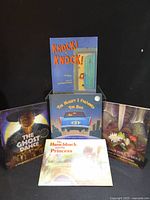 Group shot of all five children's books standing and lying on surface