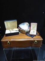 Group shot of jewellery chest, heart box, watch in case, bracelet, ring case