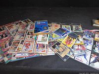Overhead of entire lot showing stacks of hockey cards in sleeves and the book