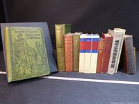 Full group of 12 books lined up showing spines and sizes