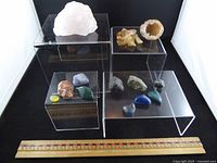 Group shot of all rocks on acrylic risers with ruler for scale