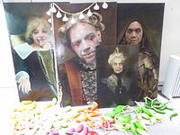 Group of four vampire canvas prints with pile of artificial peppers