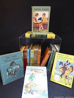 Group shot of books showing fronts and spines, includes Shining Lights, Best in Children’s Books, The Little White House and others
