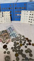 Overall view of albums, loose coins, banknotes