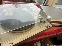 JVC L-A11 turntable next to Apex combo deck, dust cover closed