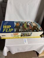 Full view of Hip Flip game box with ruler for scale