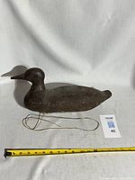 Full side view of decoy with tape measure and attached string