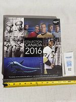 Front cover of sealed 2016 Collection Canada yearbook with ruler for scale and lot tag