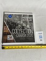 Front view of sealed Collection Canada 2020 book beside ruler