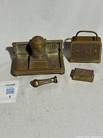 Full view of four brass desk pieces