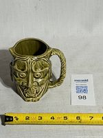 Front view showing devil face design, measuring tape indicates width