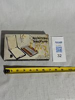 Boxed Britway telephone list finder beside ruler for scale