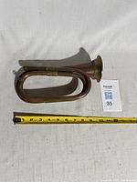 Bugle side view with tape measure showing length