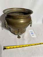 Front view showing overall shape, lion feet, tape for scale