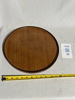 Top view of teak tray with measuring tape for scale