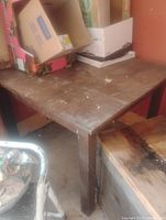 Full view of square oak table with items on top