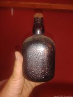 Front view of brown crackle-pattern bottle with cork